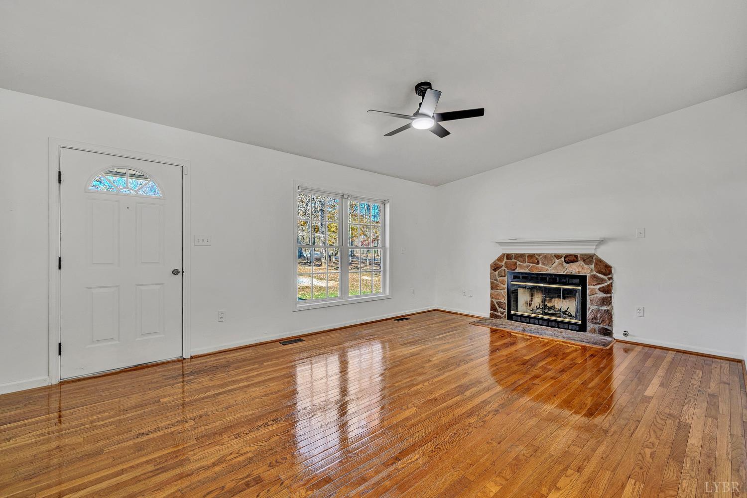 3949 Diamond Hill Road Moneta, VA 24121 - Photo 3 of 30 a view of empty room with wooden floor and fan
