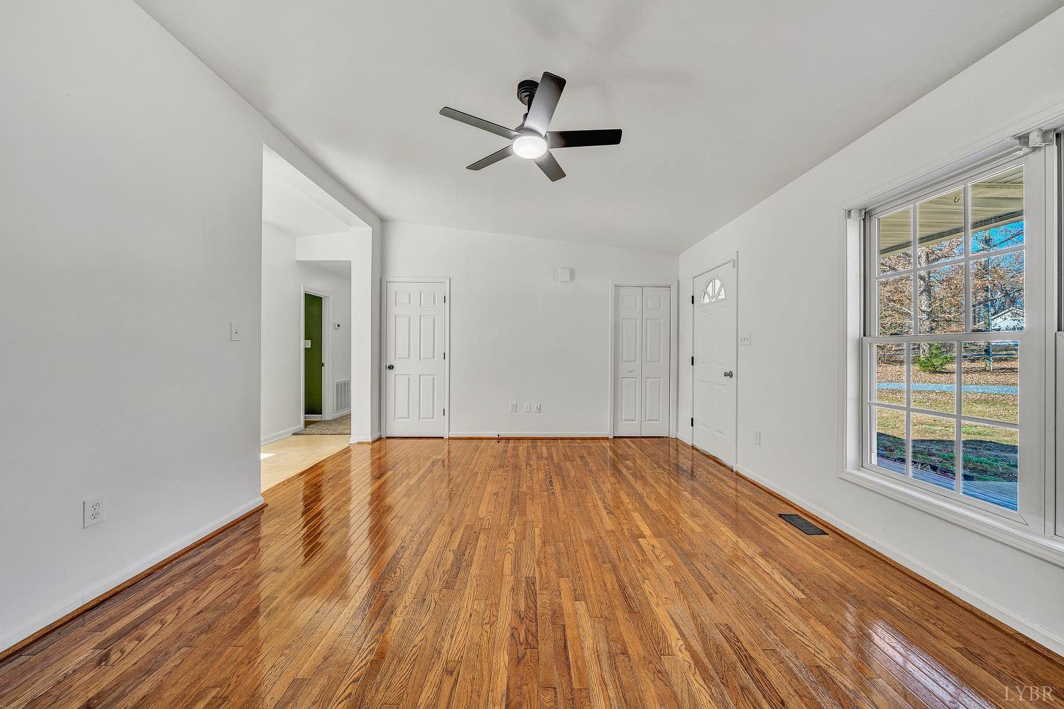 3949 Diamond Hill Road Moneta, VA 24121 - Photo 5 of 30 a view of empty room with wooden floor and fan