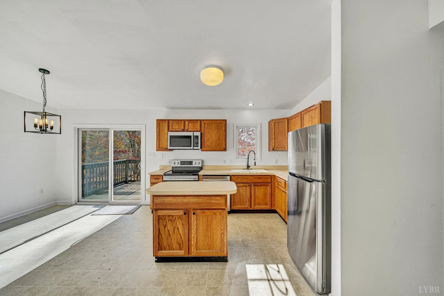 3949 Diamond Hill Road Moneta, VA 24121 - Photo 6 of 30 a room with a balcony a bed and a flat screen tv