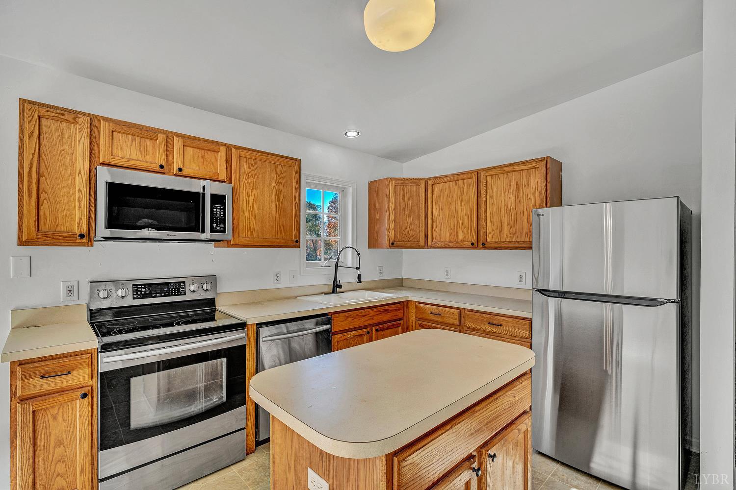 3949 Diamond Hill Road Moneta, VA 24121 - Photo 7 of 30 a kitchen with a refrigerator a stove a sink and a microwave