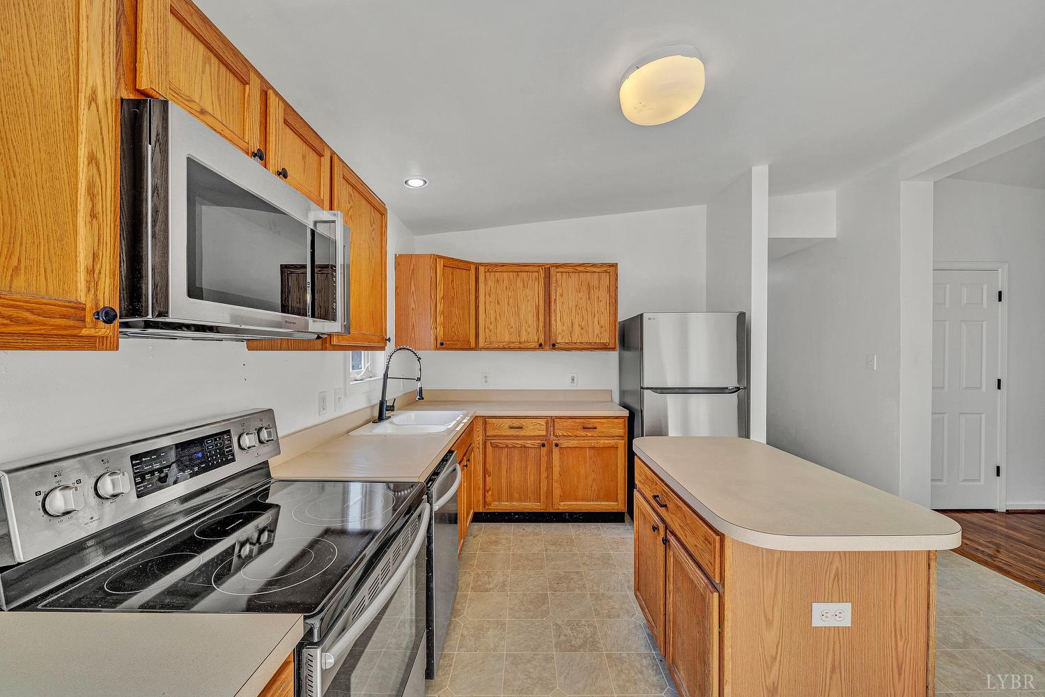 3949 Diamond Hill Road Moneta, VA 24121 - Photo 8 of 30 a kitchen that has a sink stainless steel appliances and cabinets