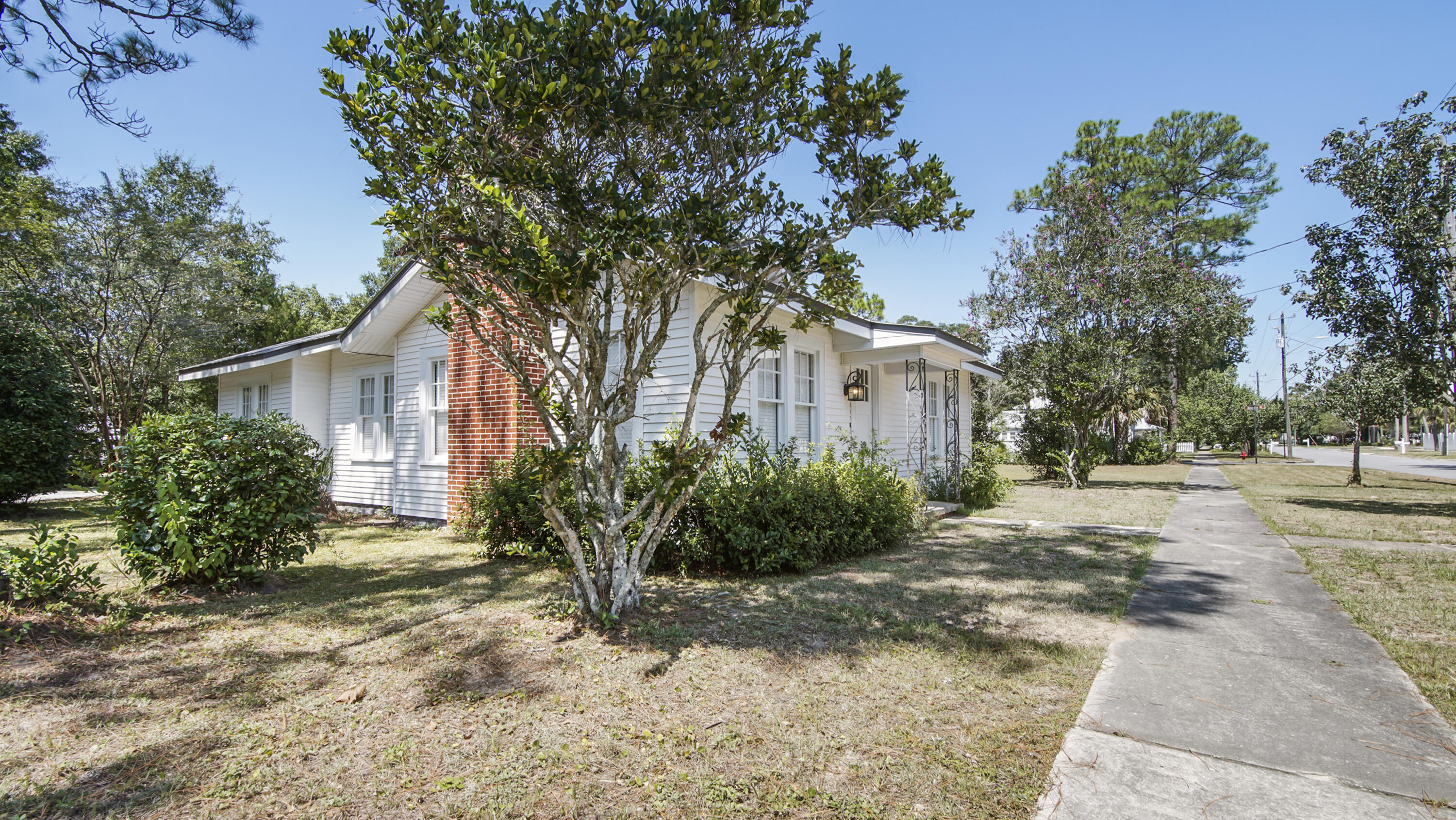 a view of a house with a tree in front