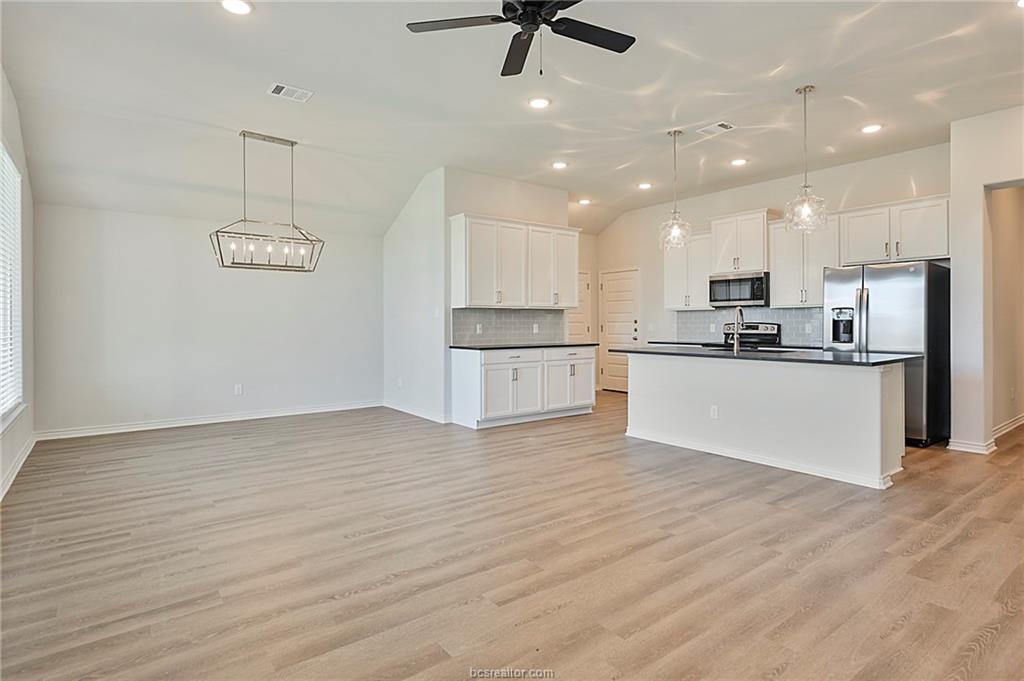 3124 Tarleton Court Bryan, TX 77808 - Photo 4 of 22 a view of kitchen with stainless steel appliances refrigerator stove microwave and cabinets
