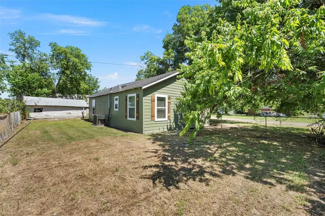 a backyard of a house with lots of green space
