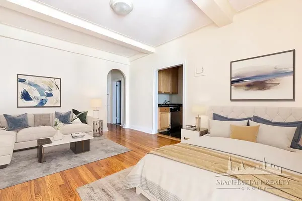 a bedroom with furniture and a painting on the wall