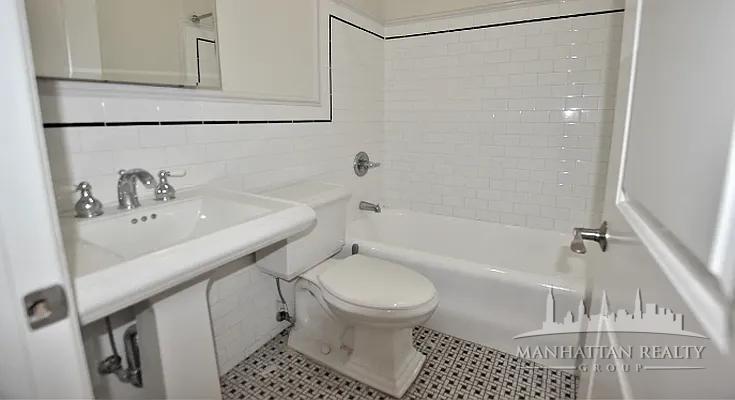 166 2nd Avenue, Unit 3M Manhattan, NY 10003 - Photo 5 of 7 a bathroom with a sink toilet and shower
