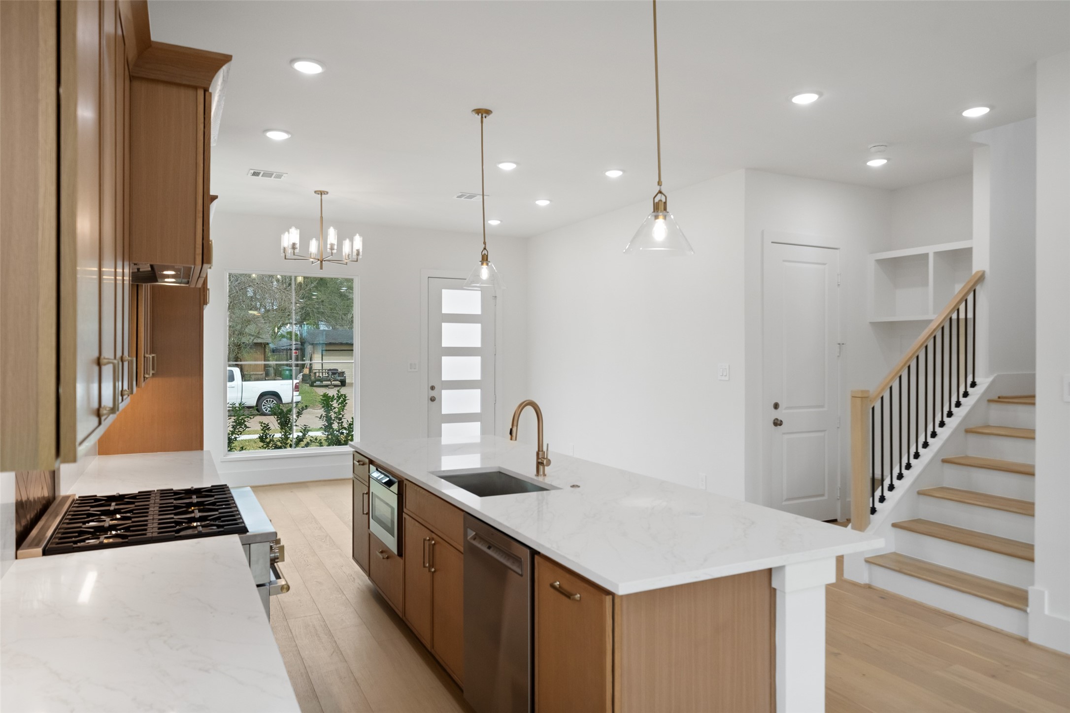 8521 Friendship Road Houston, TX 77080 - Photo 13 of 49 a kitchen with stainless steel appliances a sink a stove a refrigerator and a window
