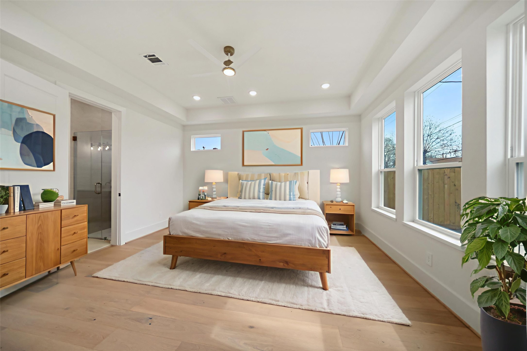 8521 Friendship Road Houston, TX 77080 - Photo 20 of 49 a spacious bedroom with a large bed and a potted plant