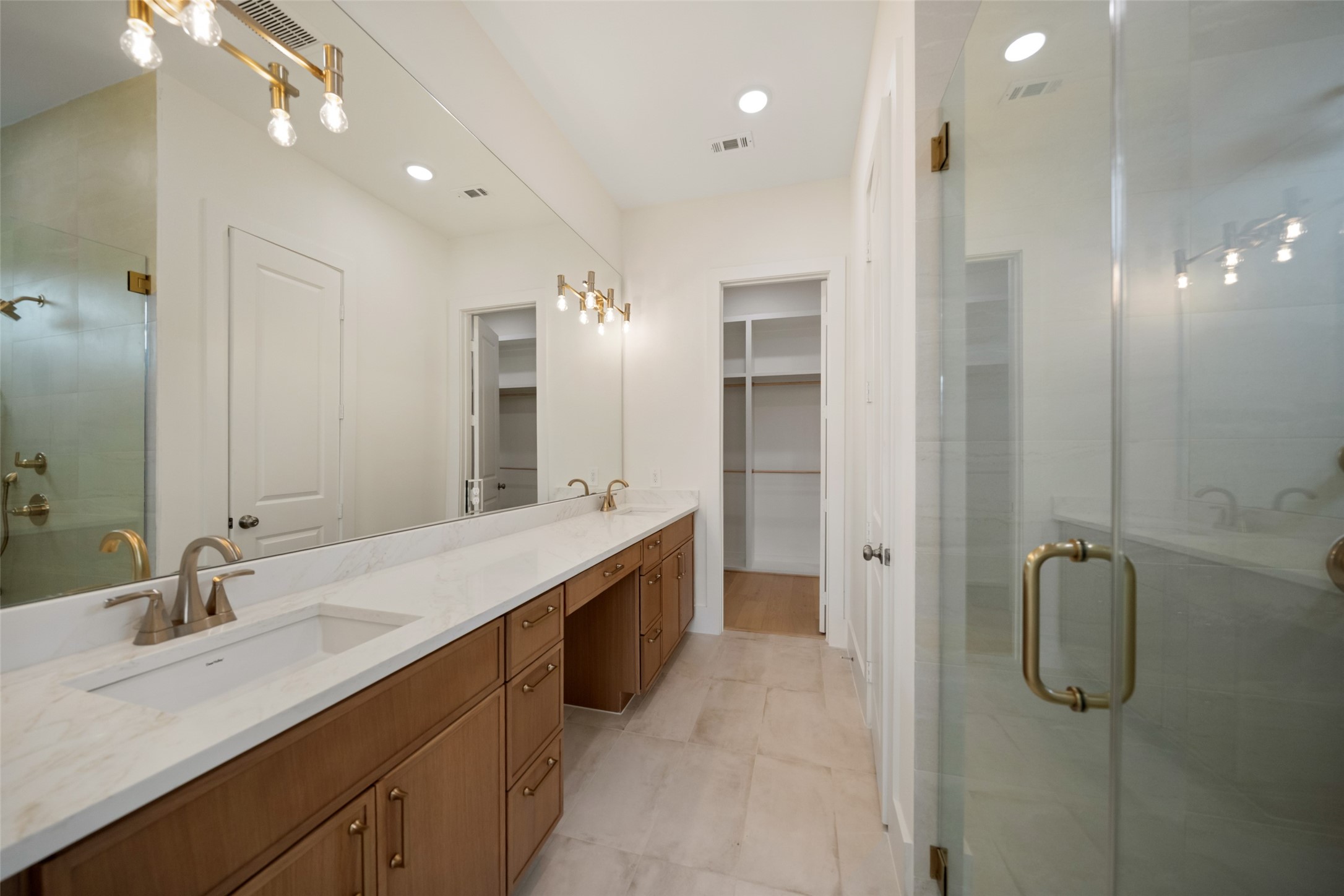 8521 Friendship Road Houston, TX 77080 - Photo 23 of 49 a bathroom with a double vanity sink a mirror and a shower
