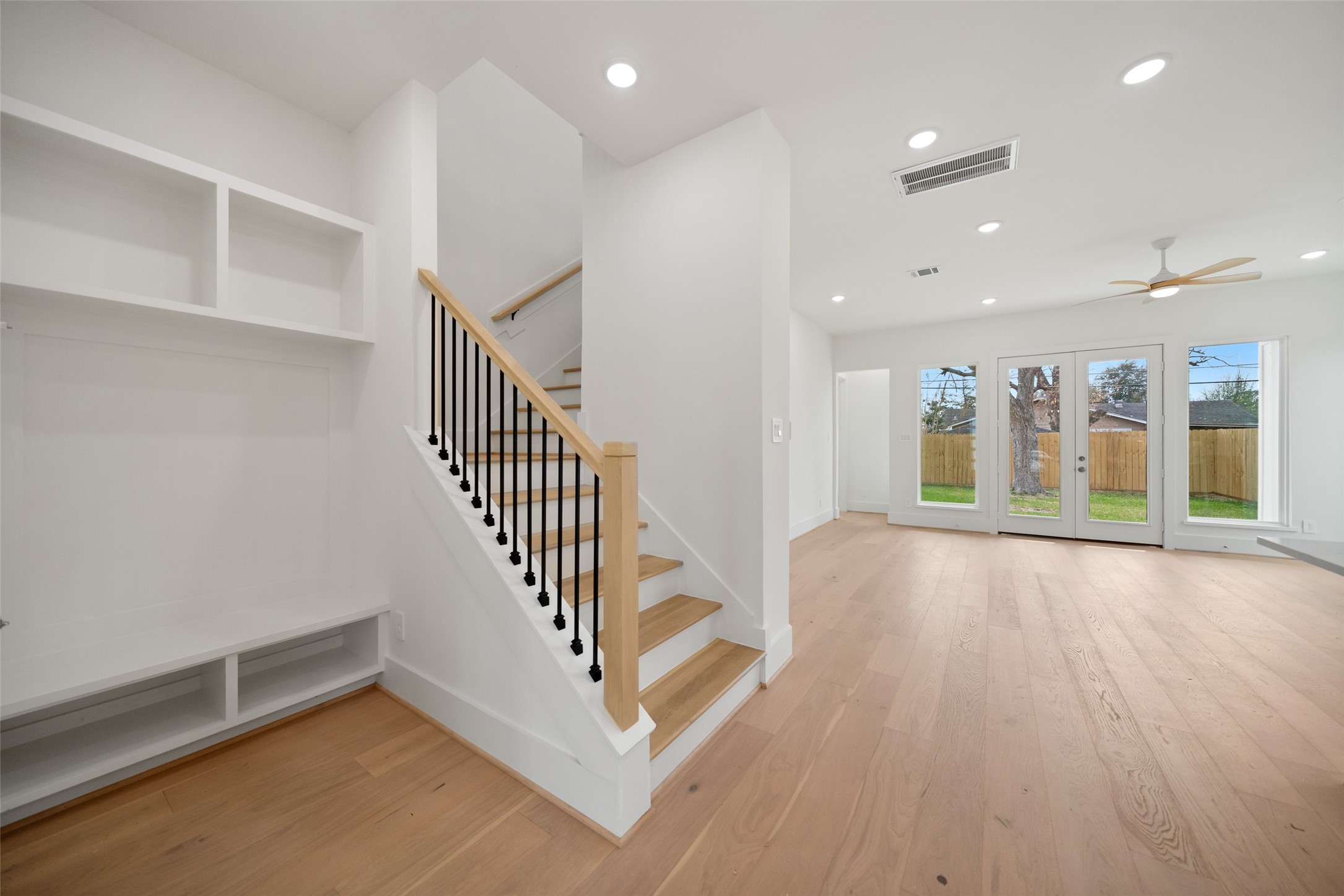 8521 Friendship Road Houston, TX 77080 - Photo 26 of 49 an entryway at an empty room with wooden floor and stairs