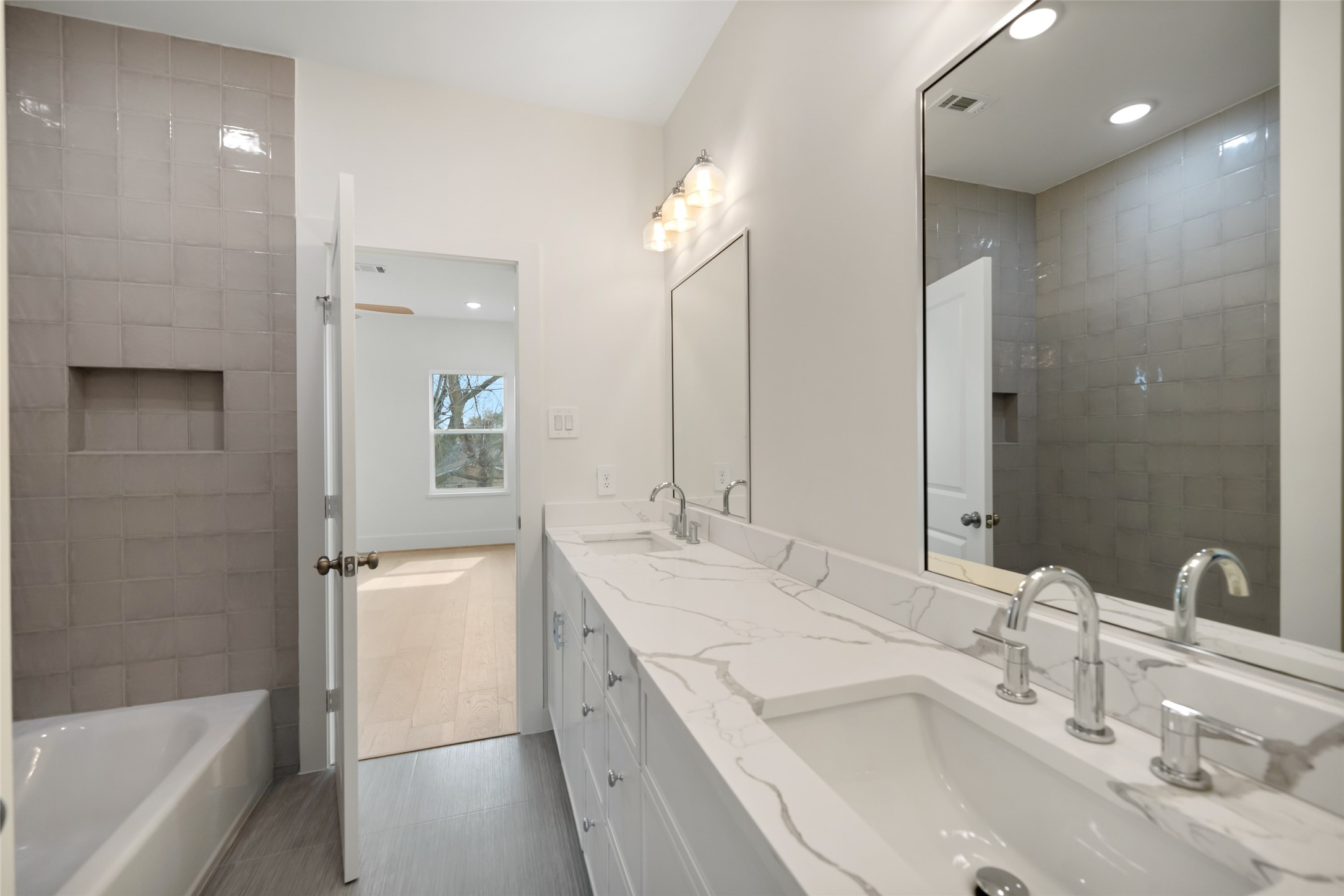 8521 Friendship Road Houston, TX 77080 - Photo 39 of 49 a bathroom with a tub double vanity sink and mirror