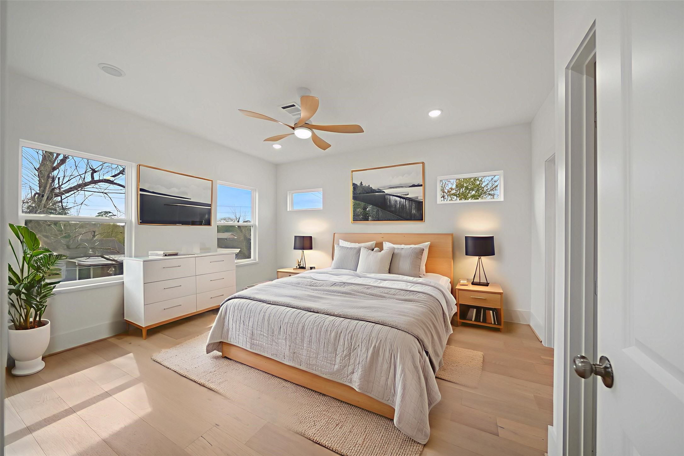 8521 Friendship Road Houston, TX 77080 - Photo 41 of 49 a bedroom with a large bed a flat tv screen and a chandelier