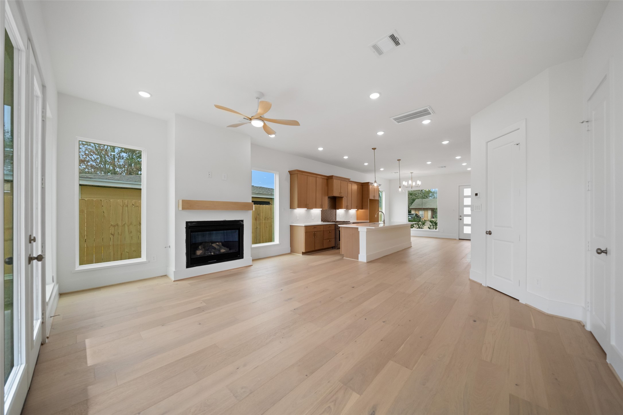 8521 Friendship Road Houston, TX 77080 - Photo 5 of 49 a view of a livingroom with a fireplace a ceiling fan and windows