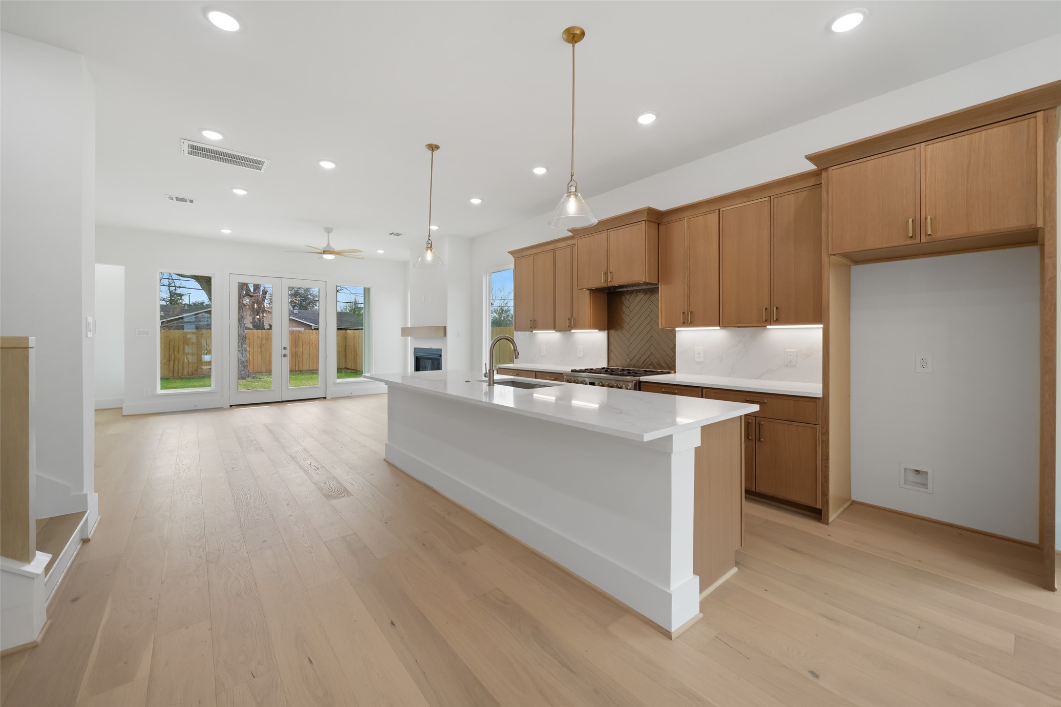 8521 Friendship Road Houston, TX 77080 - Photo 9 of 49 a large kitchen with stainless steel appliances granite countertop a large counter top a sink and a wooden floors