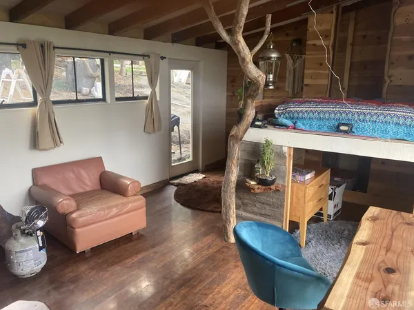 a living room with couches and a dining table with kitchen view