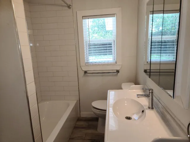 a bathroom with a sink a toilet and a bathtub
