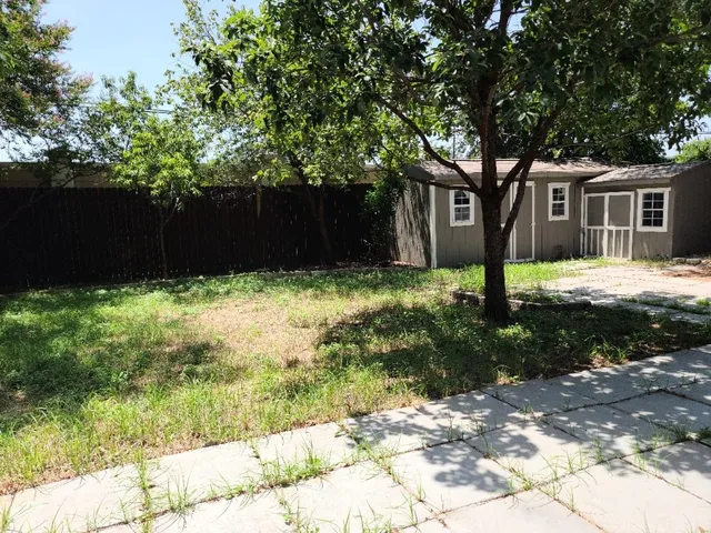 a house is sitting in middle of the garden
