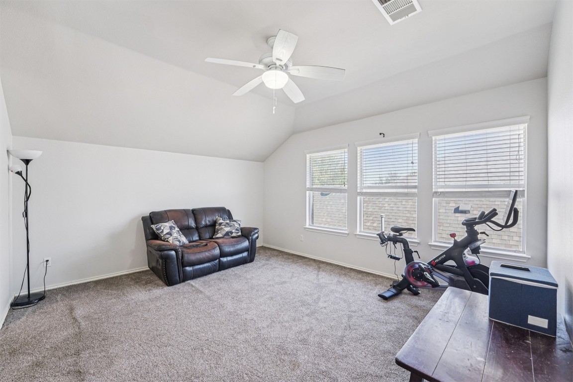 2301 Ambling Trail Pflugerville, TX 78660 - Photo 14 of 34 a living room with furniture a window and gym equipment