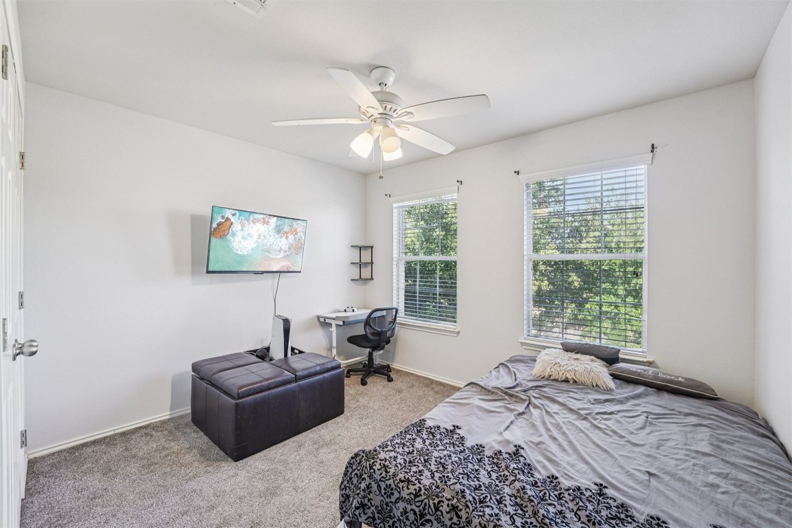 2301 Ambling Trail Pflugerville, TX 78660 - Photo 17 of 34 a bedroom with bed couch and window