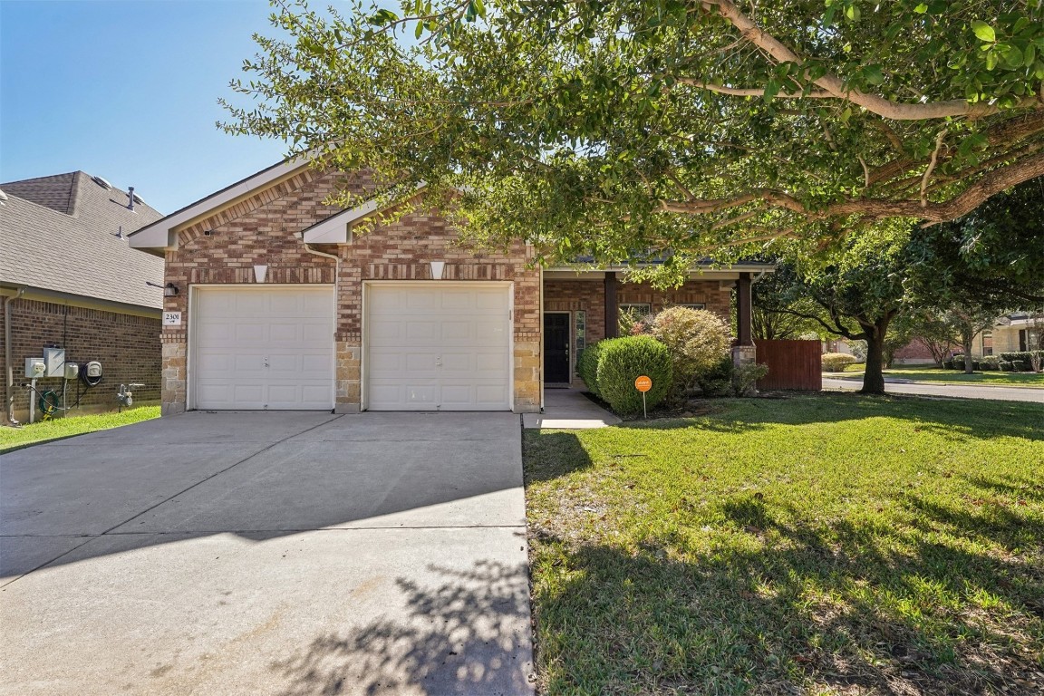 2301 Ambling Trail Pflugerville, TX 78660 - Photo 2 of 34 a house with trees in front of it