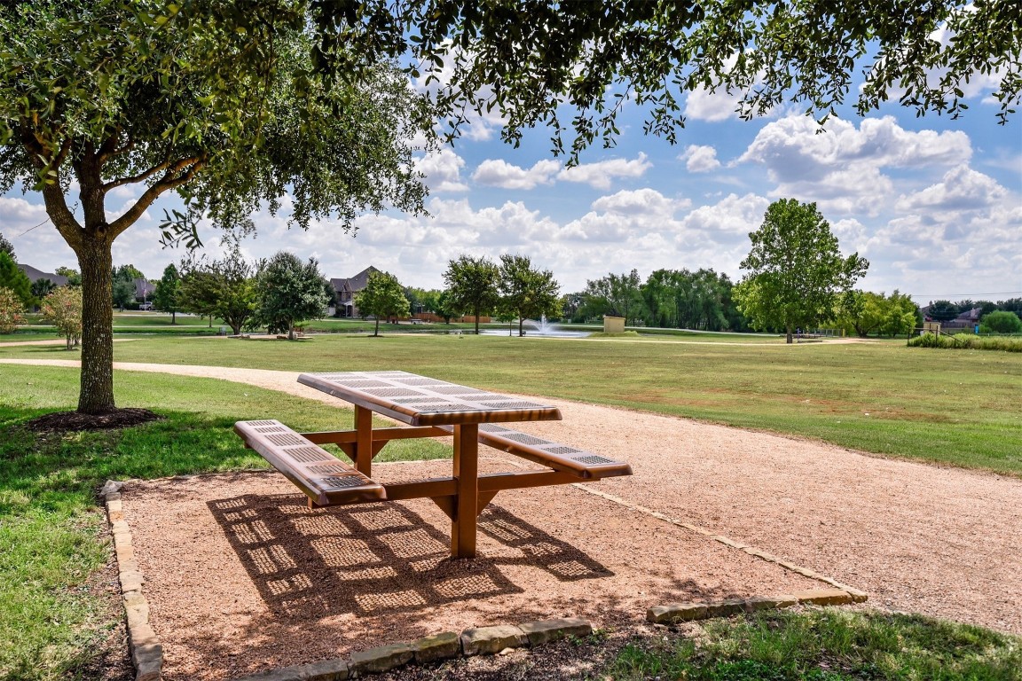 2301 Ambling Trail Pflugerville, TX 78660 - Photo 31 of 34 a view of a lake with a yard and a large tree