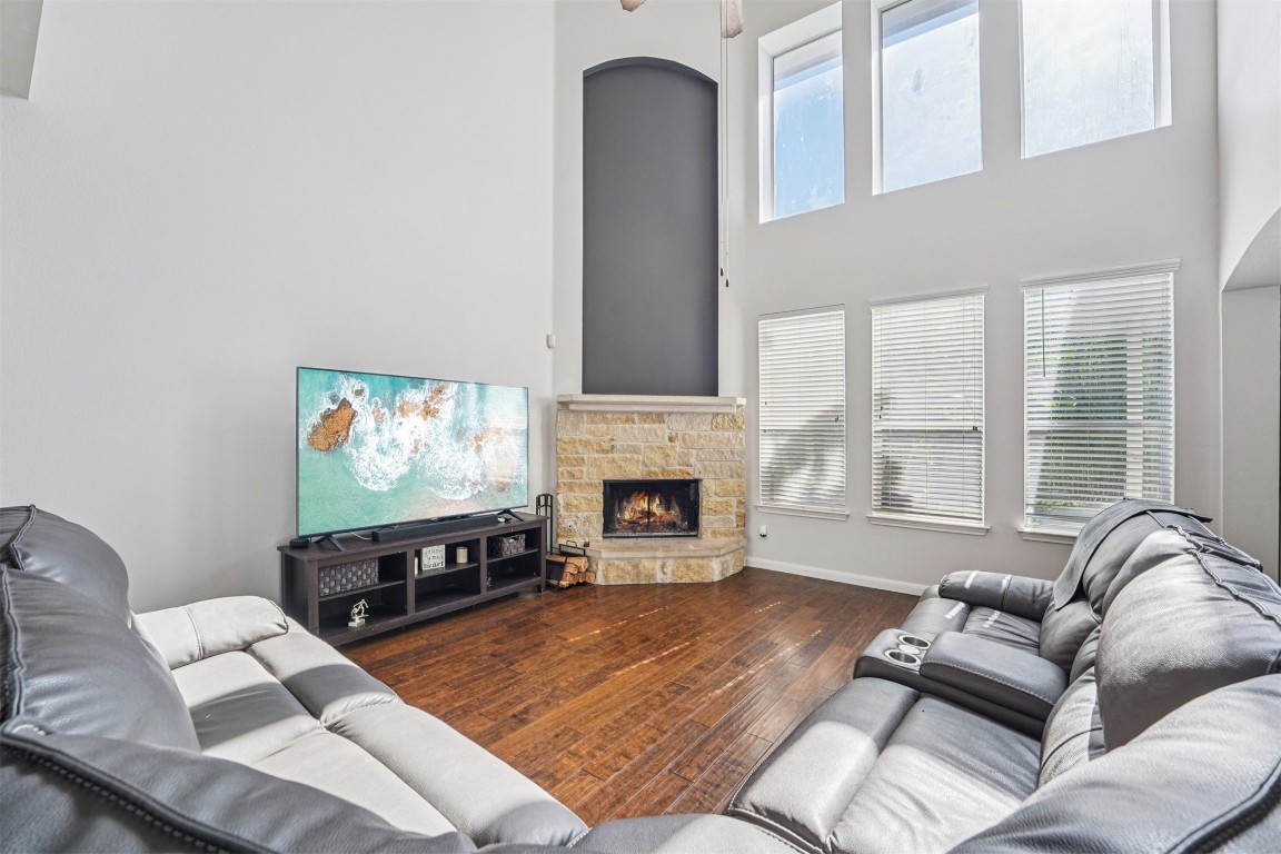 2301 Ambling Trail Pflugerville, TX 78660 - Photo 6 of 34 a living room with furniture a fireplace and a flat screen tv