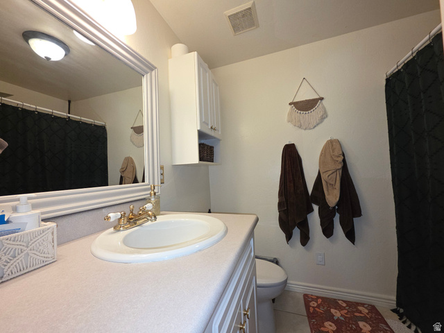 387 North Loafer Canyon Road Payson, UT 84651 - Photo 58 of 94 Bathroom featuring a vanity with an integrated sink, a large framed mirror, and a wall-mounted storage cabinet