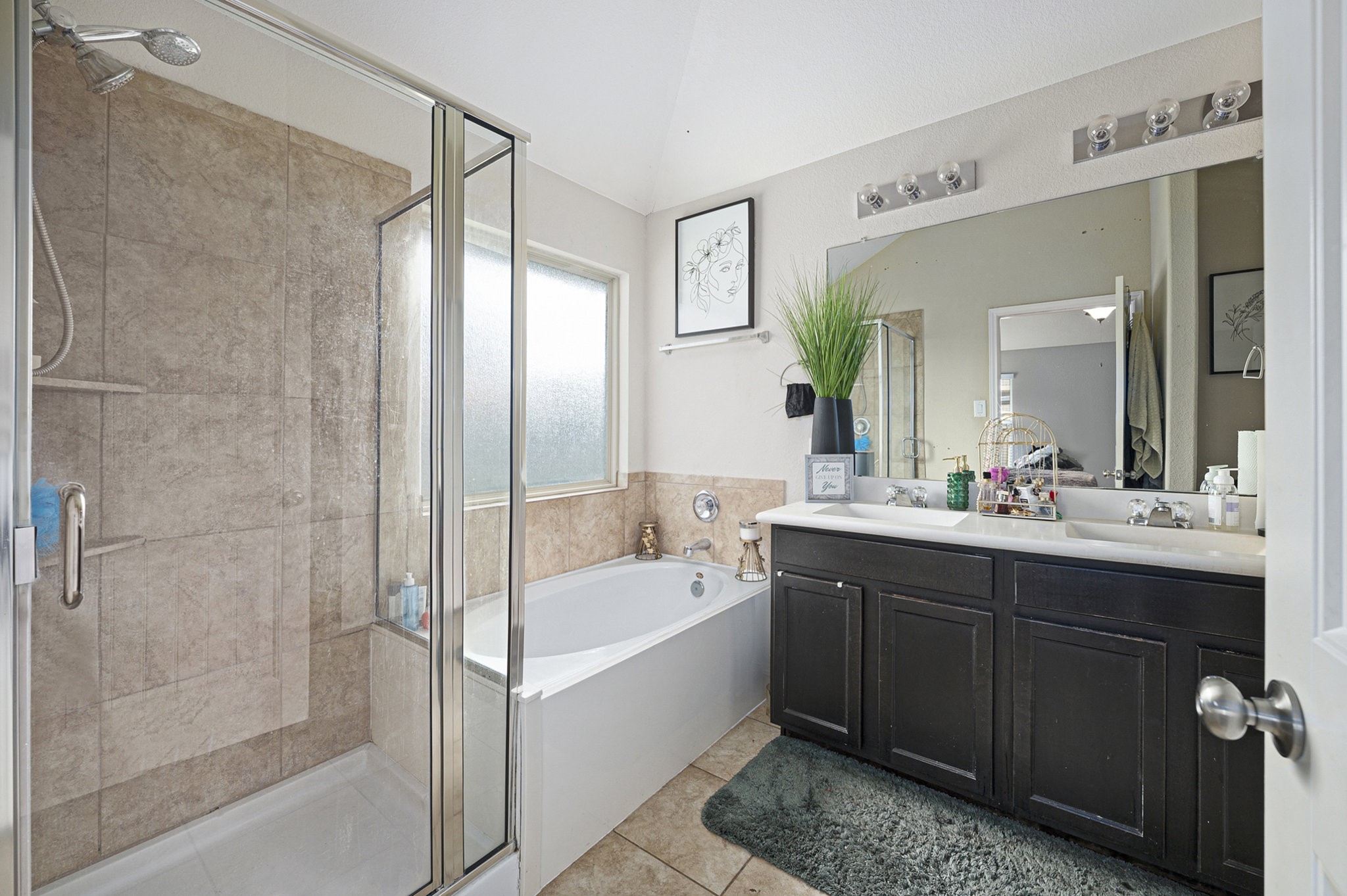 20719 Winghaven Drive Katy, TX 77449 - Photo 13 of 22 a bathroom with a tub sink shower and mirror
