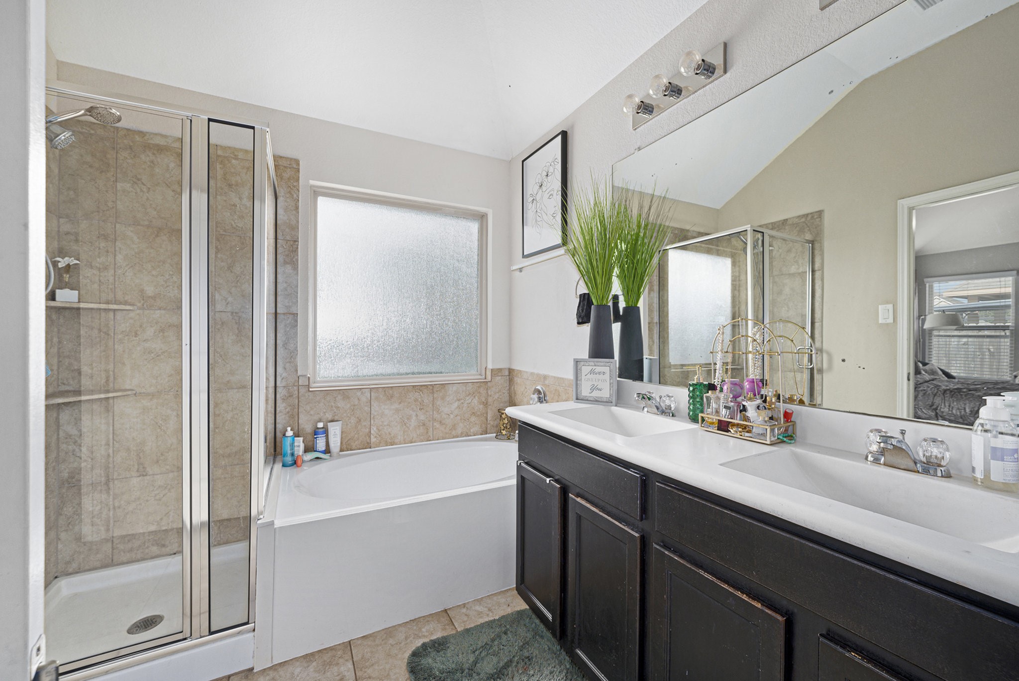 20719 Winghaven Drive Katy, TX 77449 - Photo 14 of 22 a bathroom with a tub sink and mirror