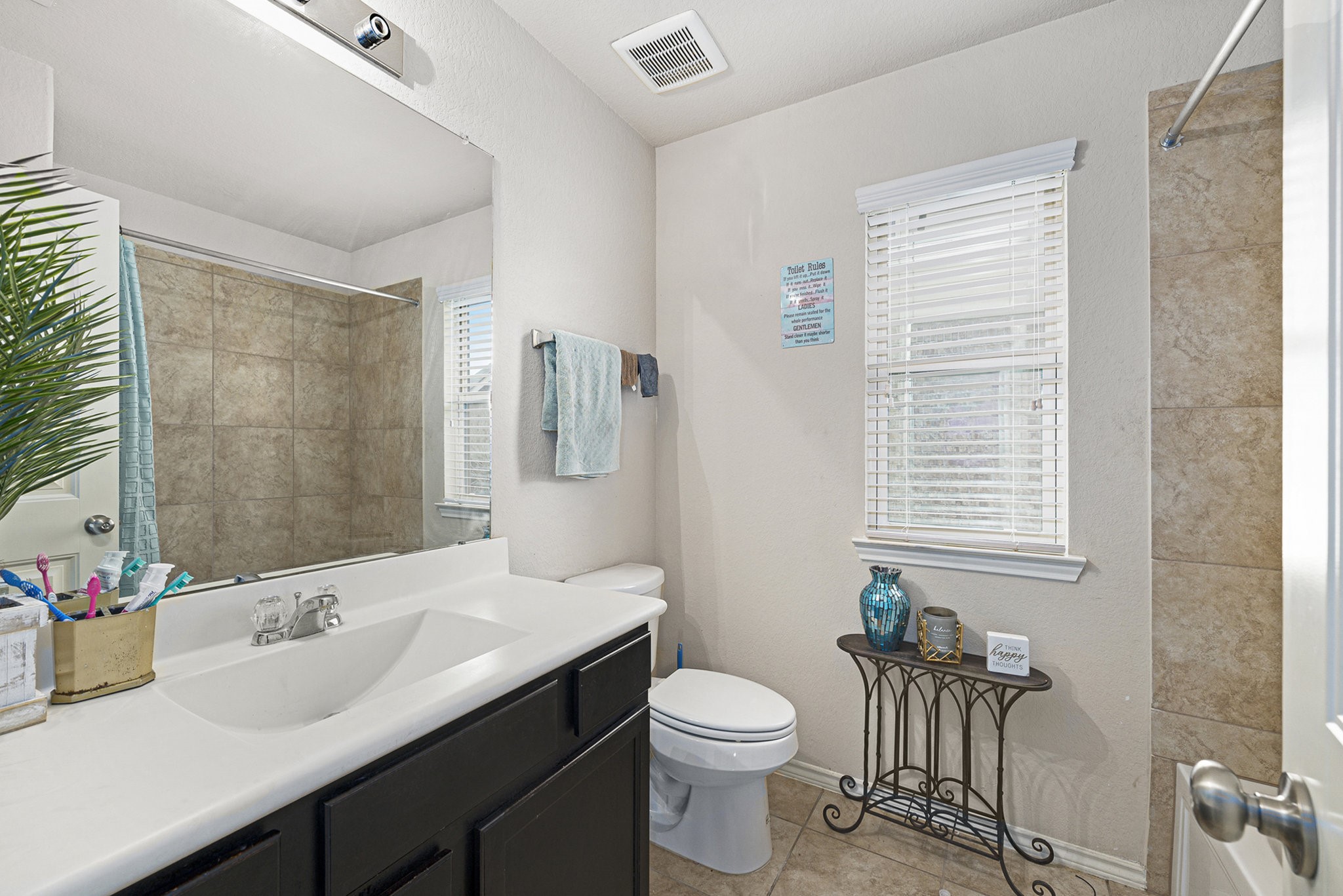 20719 Winghaven Drive Katy, TX 77449 - Photo 17 of 22 a bathroom with a sink vanity mirror and toilet