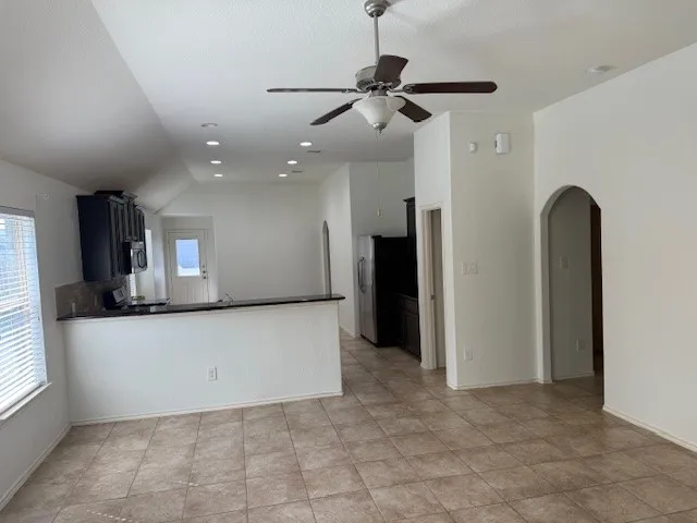 a view of a kitchen with a refrigerator and a window