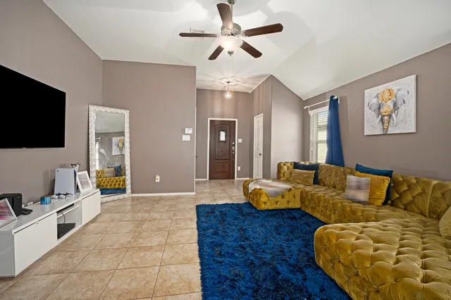 a living room with furniture and a flat screen tv