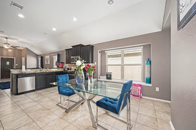 a living room with furniture and kitchen view