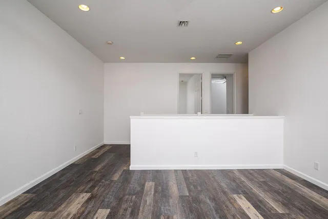 a spacious bathroom with a tub sink and a mirror