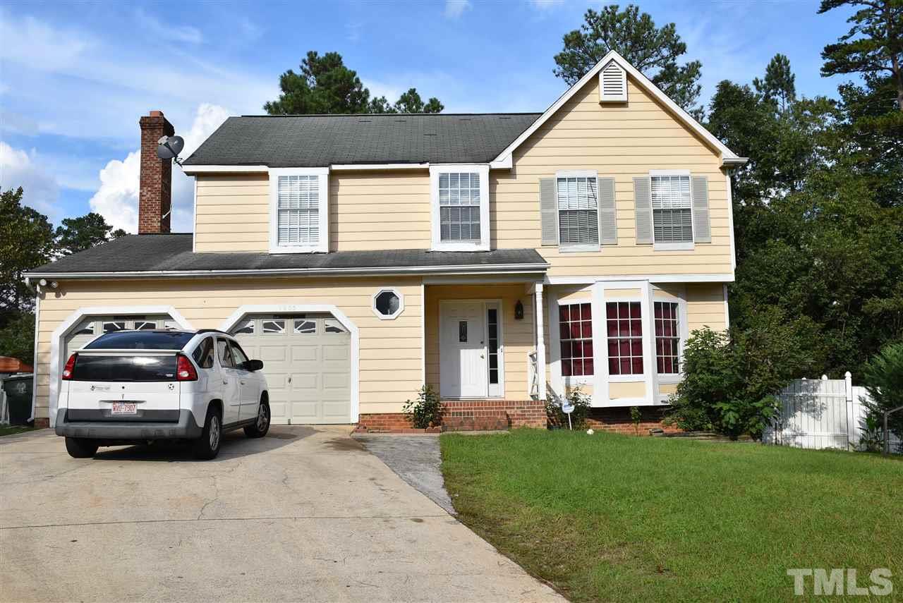 a view of a car parked in front of a house