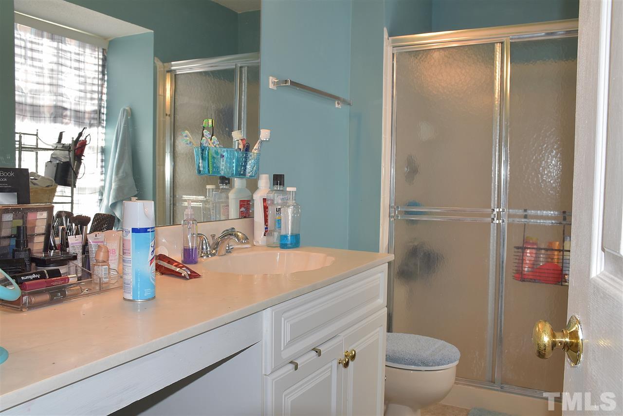 1905 Grove Point Court Raleigh, NC 27609 - Photo 3 of 3 a bathroom with a sink a toilet and a mirror