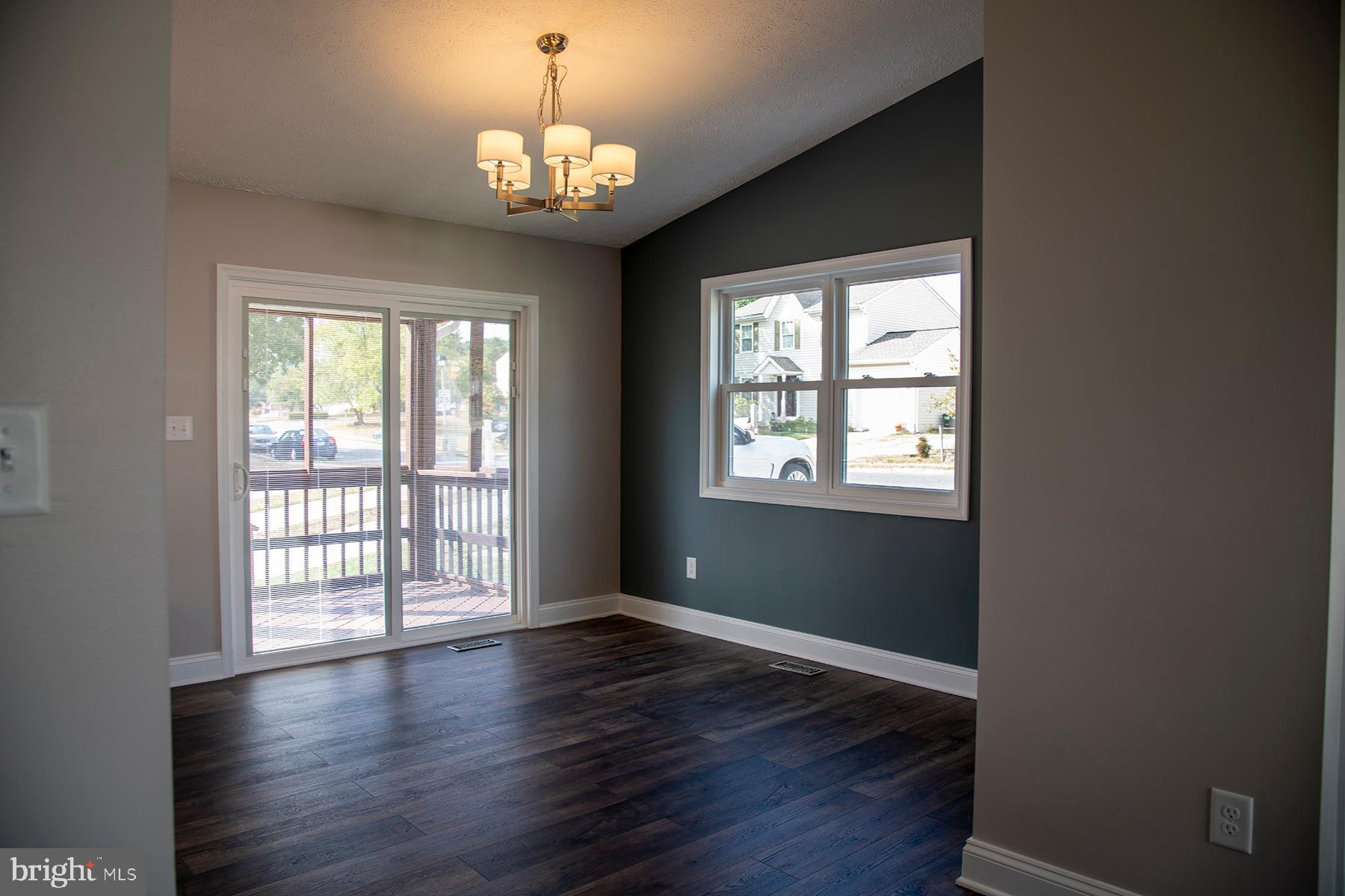 345 Edgewood Road Linthicum Heights, MD 21090 - Photo 20 of 63 a view of an empty room with wooden floor and a window