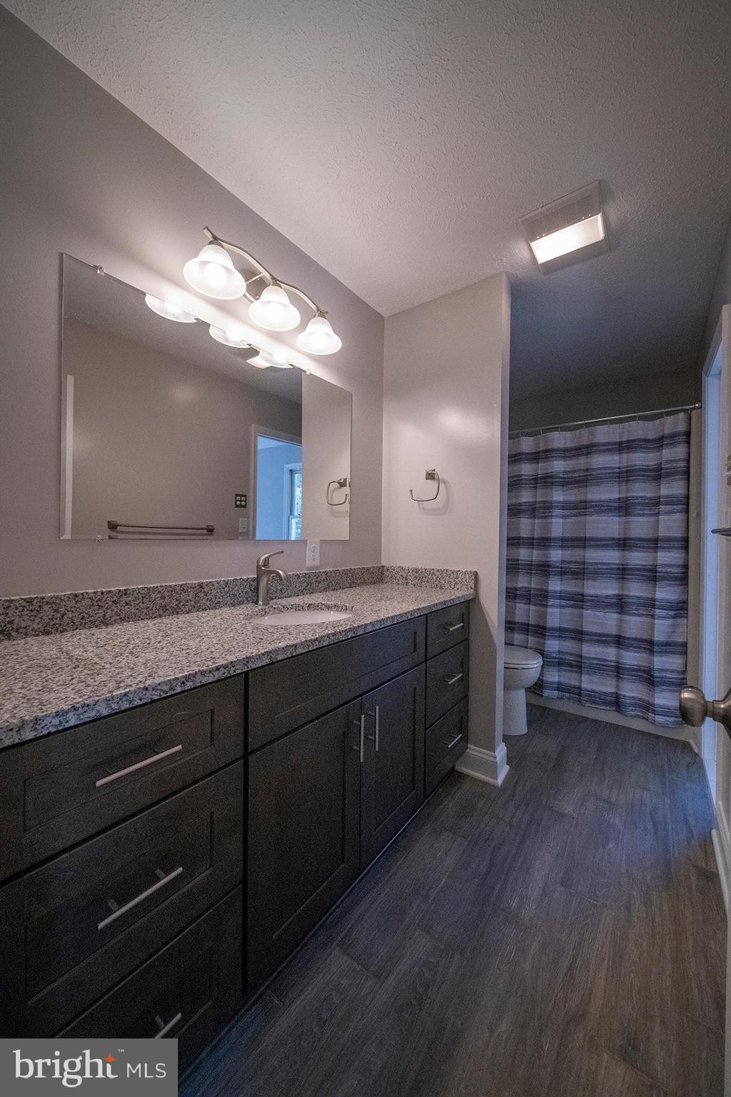 345 Edgewood Road Linthicum Heights, MD 21090 - Photo 28 of 63 a bathroom with a granite countertop sink and a mirror