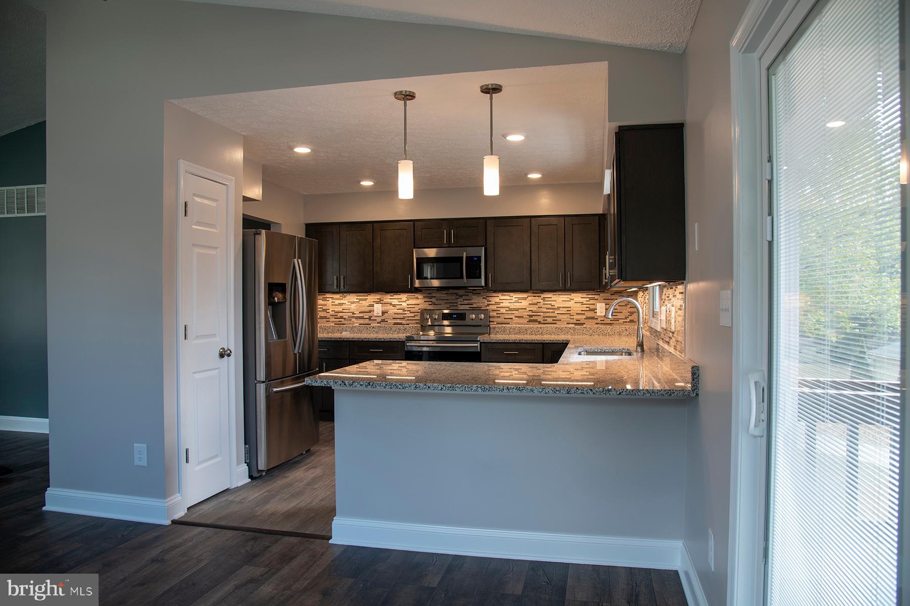 345 Edgewood Road Linthicum Heights, MD 21090 - Photo 4 of 63 a kitchen with stainless steel appliances granite countertop a sink and a refrigerator