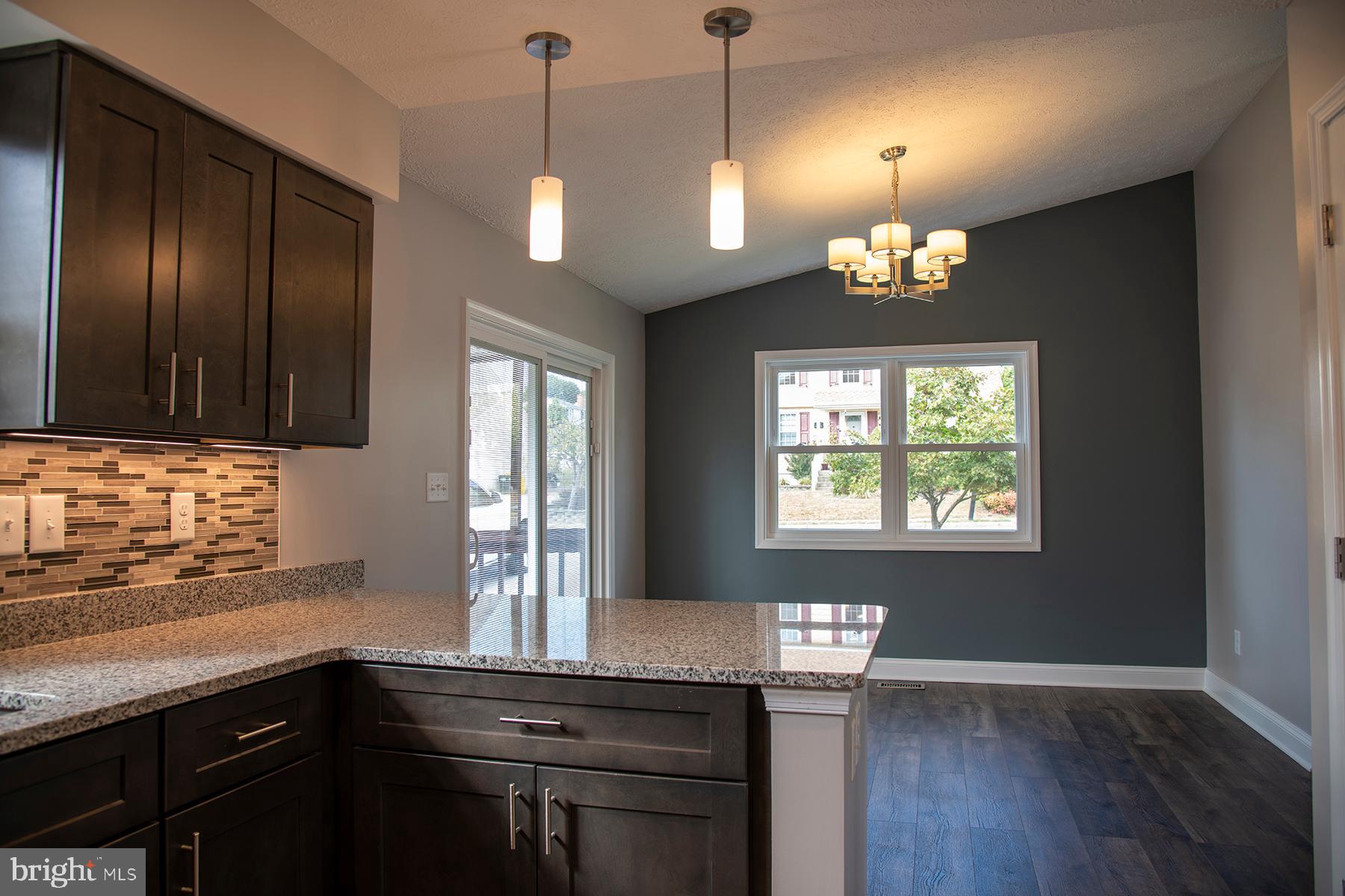 345 Edgewood Road Linthicum Heights, MD 21090 - Photo 5 of 63 a kitchen with stainless steel appliances granite countertop wooden floors and a view of living room