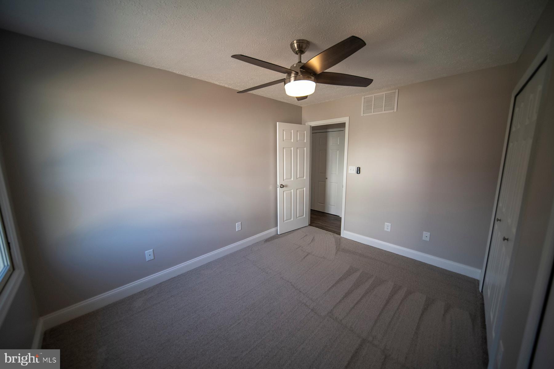 345 Edgewood Road Linthicum Heights, MD 21090 - Photo 42 of 63 an empty room with a chandelier fan and a window