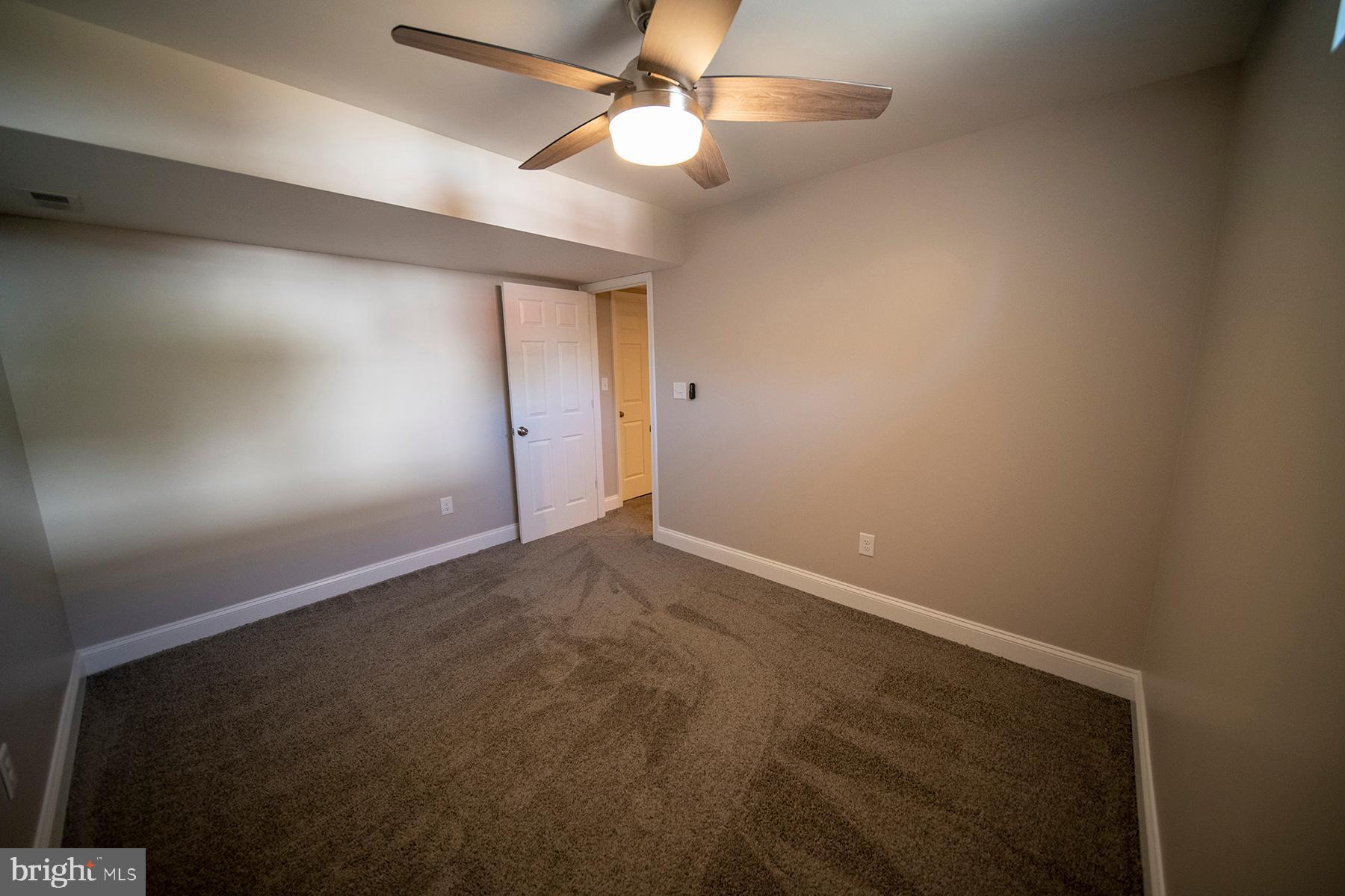 345 Edgewood Road Linthicum Heights, MD 21090 - Photo 52 of 63 en empty room with ceiling fan and window