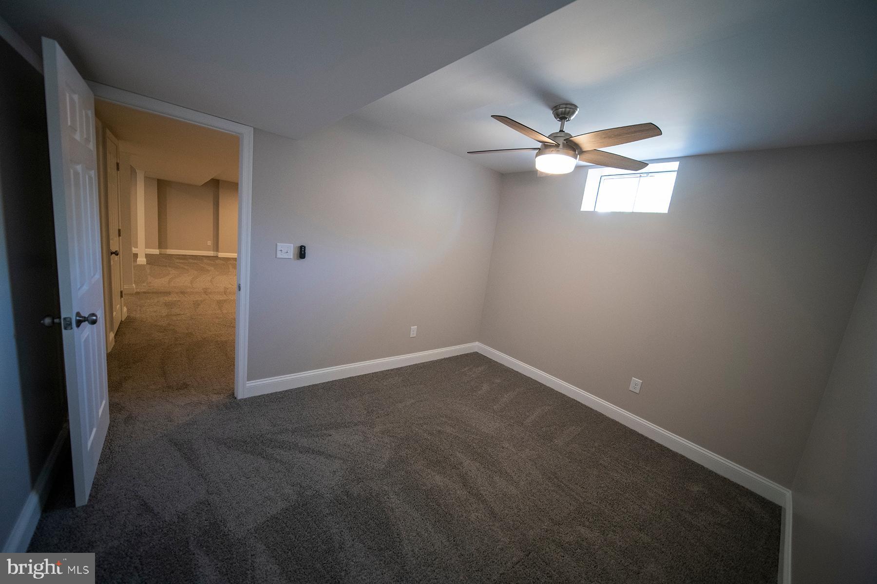 345 Edgewood Road Linthicum Heights, MD 21090 - Photo 53 of 63 en empty room with windows and fan