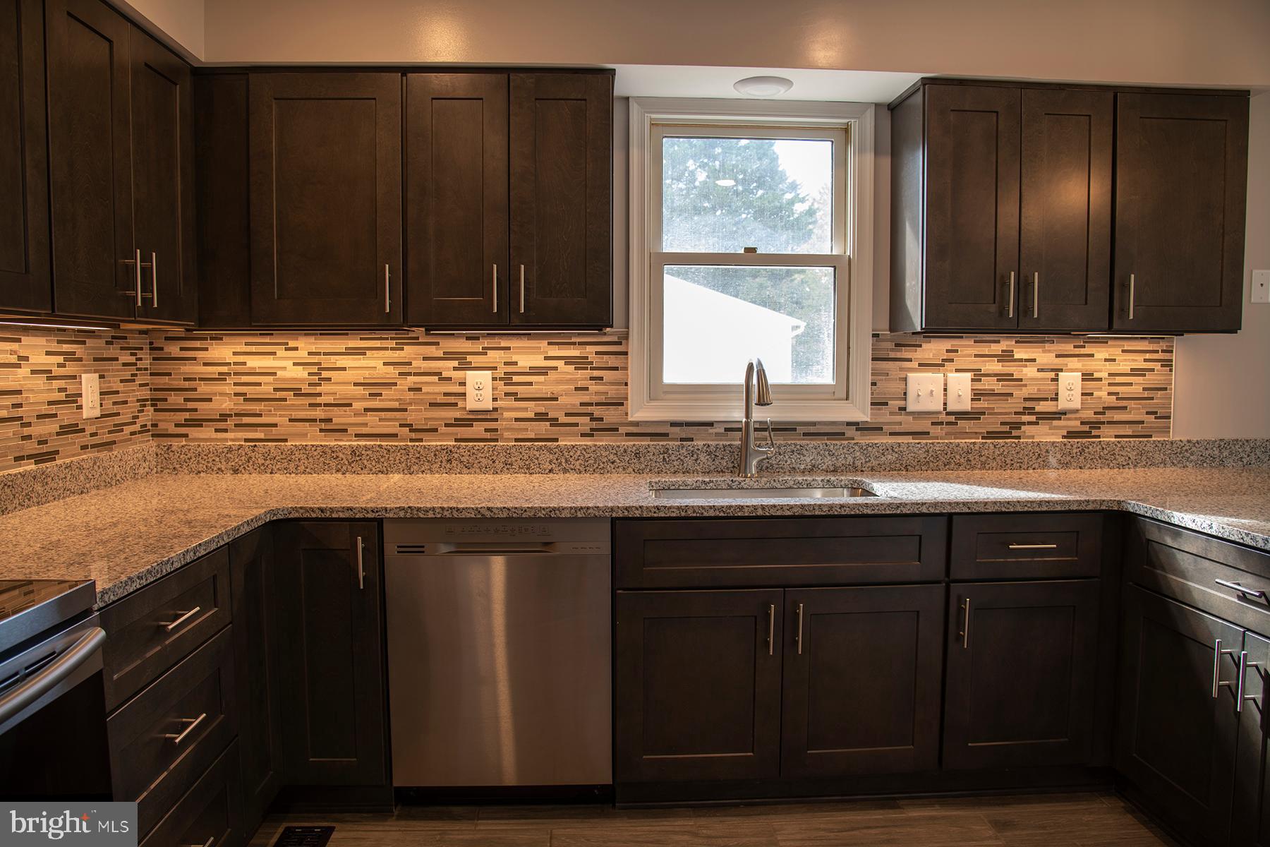 345 Edgewood Road Linthicum Heights, MD 21090 - Photo 9 of 63 a kitchen with granite countertop wooden cabinets and a sink