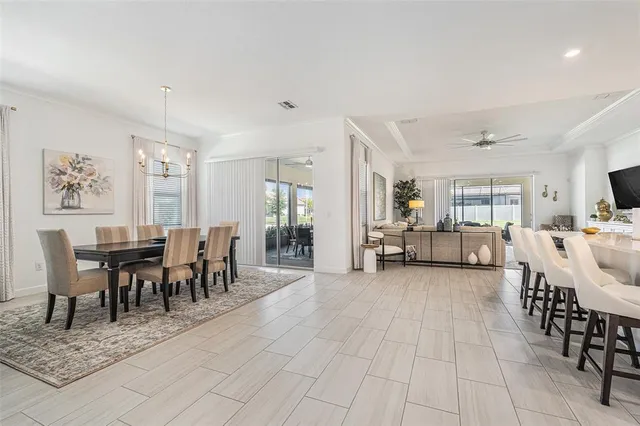 a living room with furniture a dining table and chairs with kitchen view