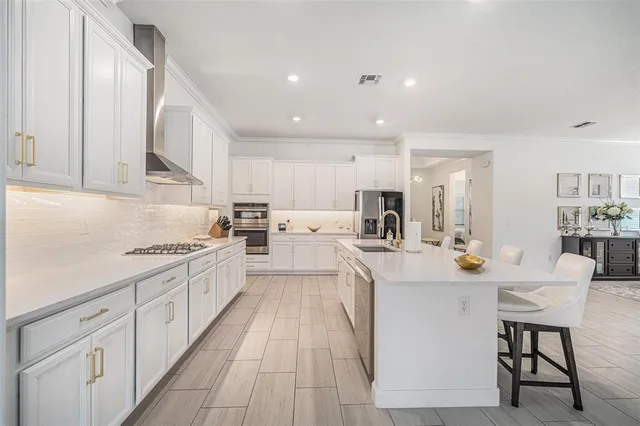 a spacious bedroom with a bed and a chandelier