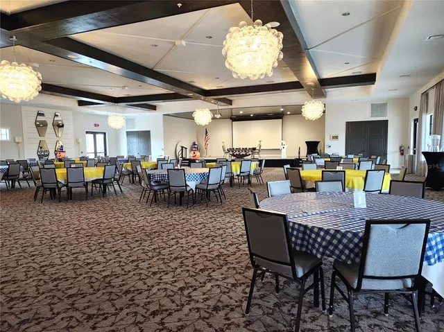 a room with pool table and windows