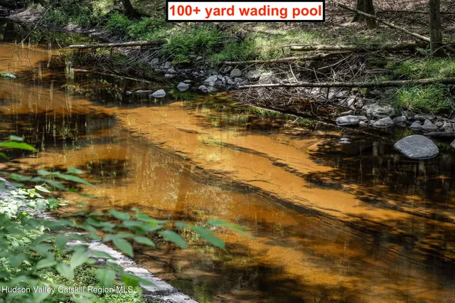 an aerial view of residential house with outdoor space and trees all around