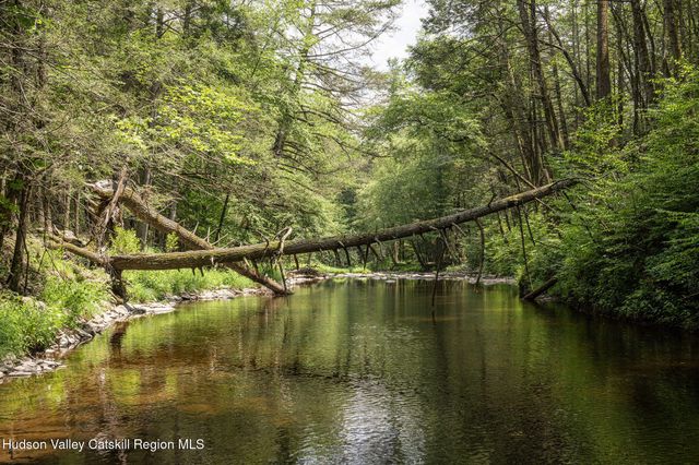a backyard of a house with a yard and outdoor seating