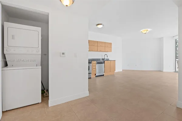 a view of a living room and entry way to kitchen